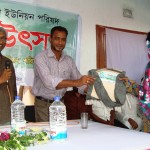 A rural women receiving best tax-payer reward organised by NRDS & Ewazbalia Union Parishad
